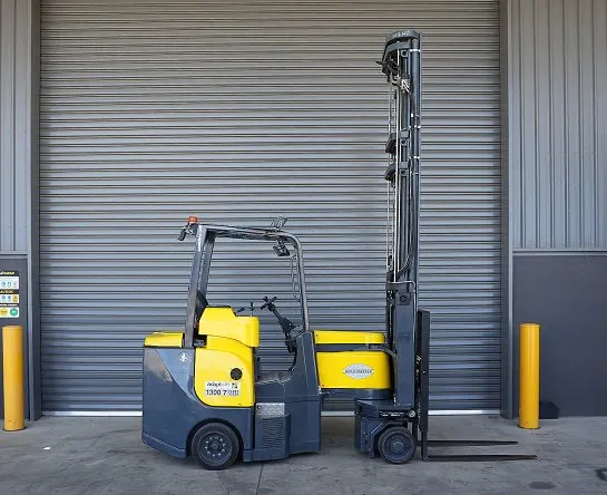 Aisle-Master articulated forklift with a high mast at a loading bay door