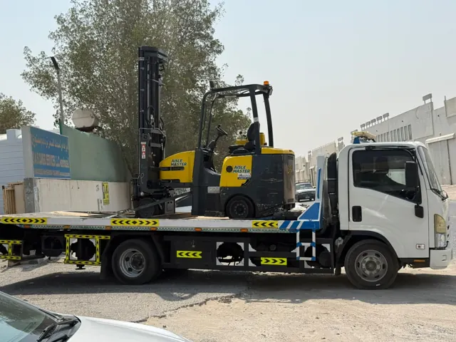 Aisle-Master articulated forklift loaded on a delivery truck