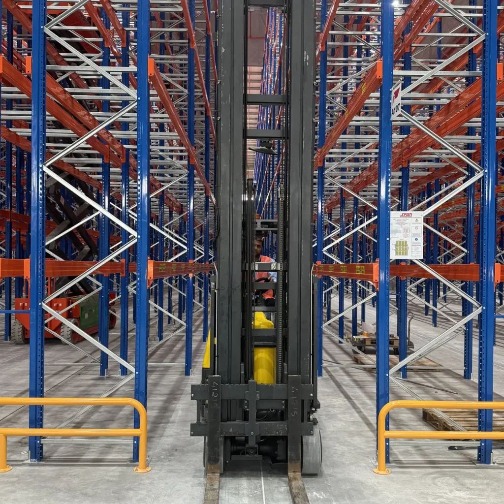 Aisle-Master articulated forklift parked in a very narrow racking aisle