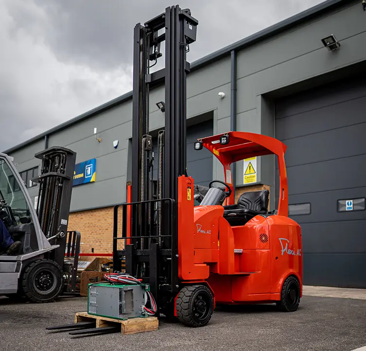 Orange Flexi articulated truck outside a warehouse